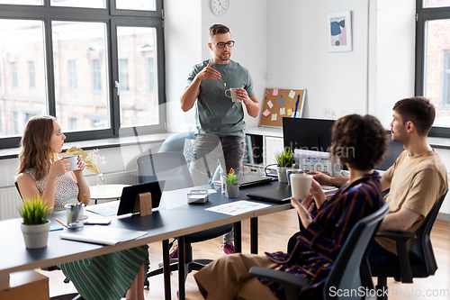 Image of team of startuppers drinking coffee at office