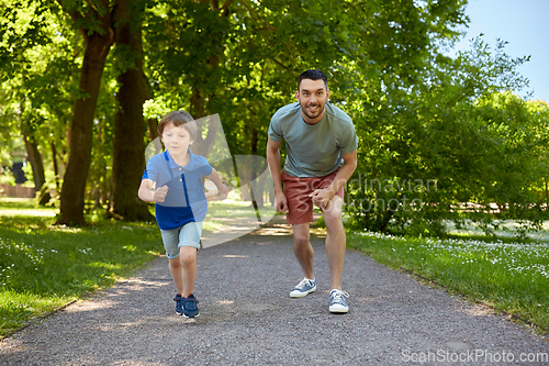 Image of happy father and son compete in running at park