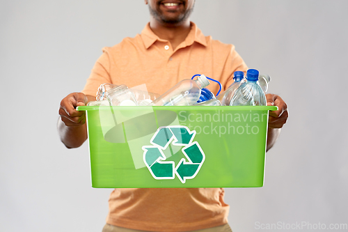 Image of close up of young man sorting plastic waste