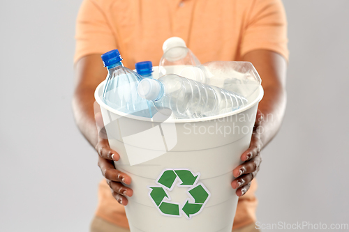 Image of close up of young man sorting plastic waste