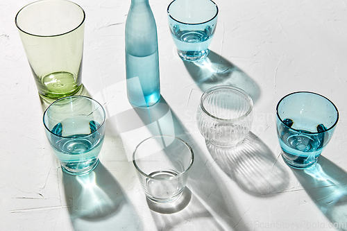 Image of glassware dropping shadows on white surface