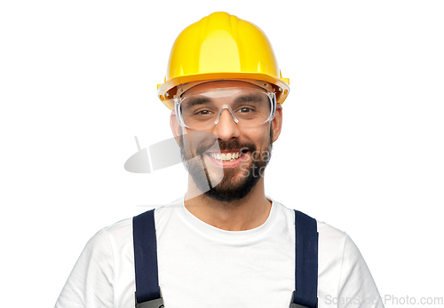 Image of happy male worker or builder in helmet and overall