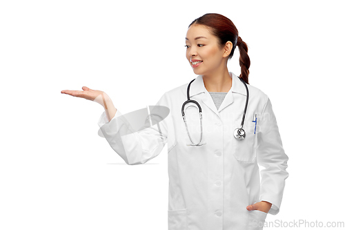 Image of asian female doctor holding something on hand