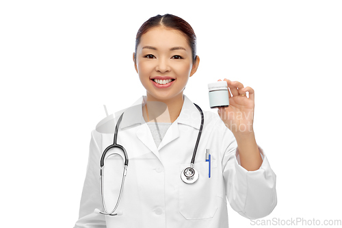 Image of smiling asian female doctor or nurse with medicine