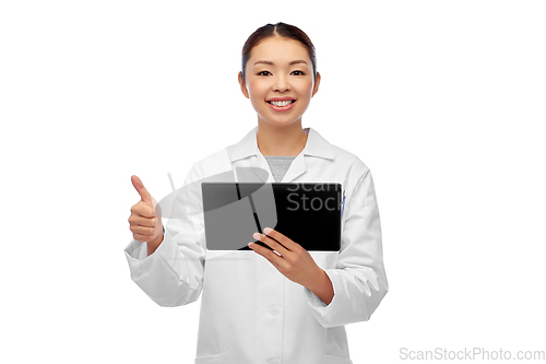 Image of asian female doctor with tablet pc shows thumbs up