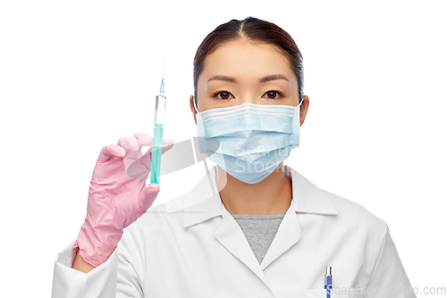 Image of asian doctor in mask with medicine in syringe