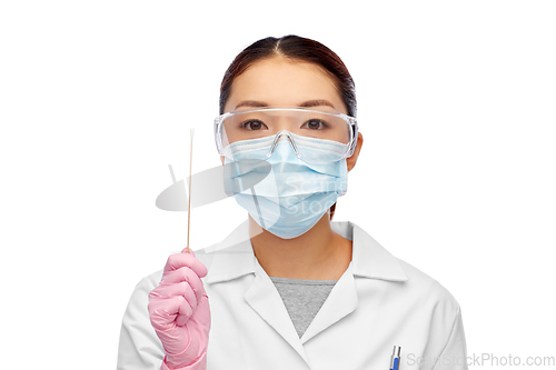 Image of asian female doctor in mask with test cotton swab