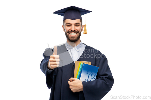 Image of happy male graduate student showing thumbs up