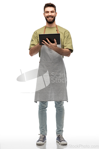 Image of smiling waiter in apron with tablet pc computer