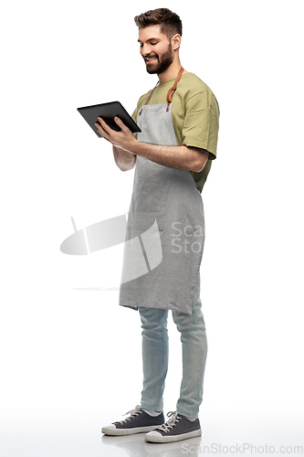 Image of smiling waiter in apron with tablet pc computer