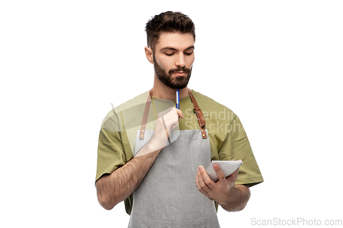 Image of waiter in apron taking notes to notepad