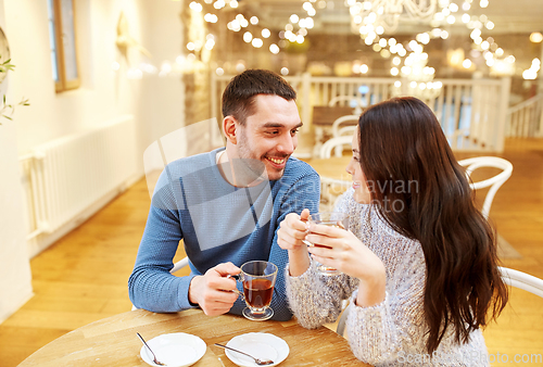 Image of happy couple drinking tea at cafe