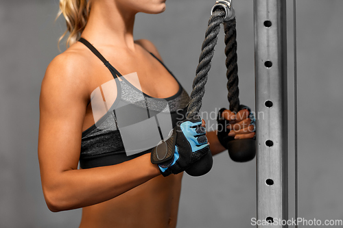 Image of close up of woman exercising with bar in gym