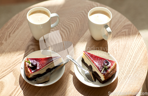 Image of pieces of chocolate cake on wooden table