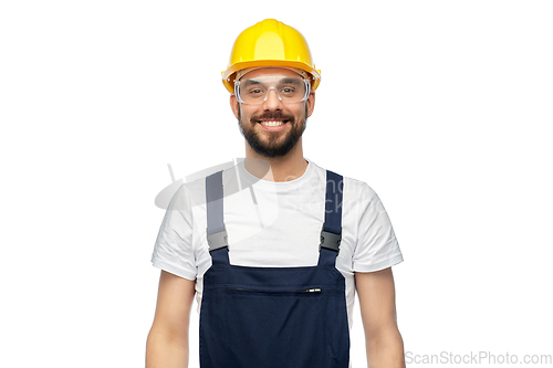 Image of happy male worker or builder in helmet and overall