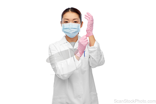 Image of asian female doctor in medical mask and gloves