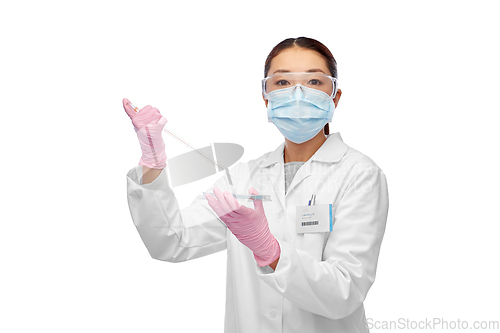 Image of asian female scientist in mask working on vaccine