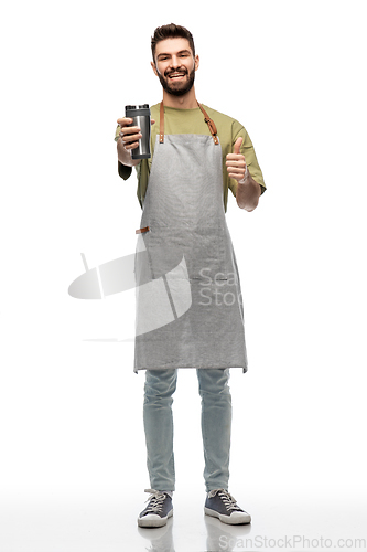 Image of happy waiter with tumbler showing thumbs up