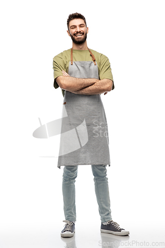 Image of happy smiling barman in apron with crossed arms