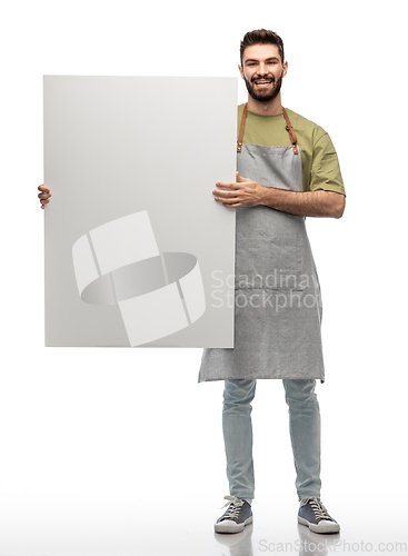 Image of happy barman in apron holding empty white board