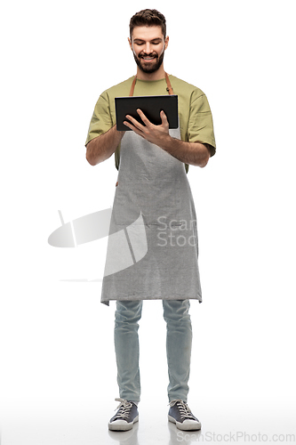 Image of smiling waiter in apron with tablet pc computer