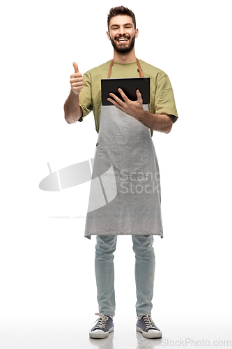 Image of smiling waiter with tablet pc showing thumbs up