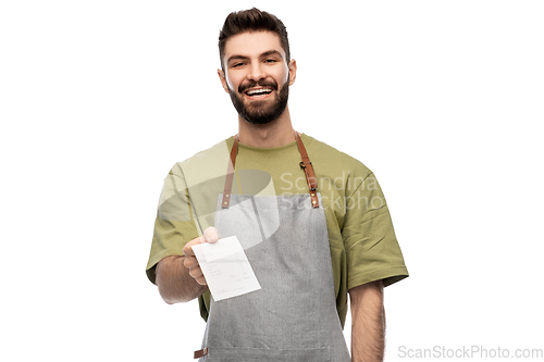 Image of happy smiling barman in apron with bill