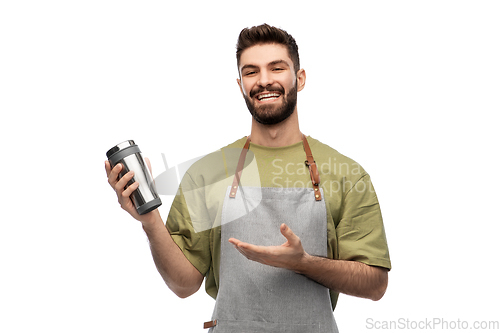 Image of happy waiter with tumbler or takeaway thermo cup