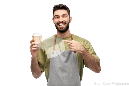 Image of happy smiling barman in apron with takeaway coffee