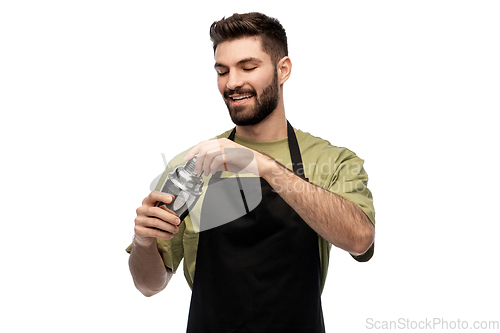 Image of happy barman with shaker preparing