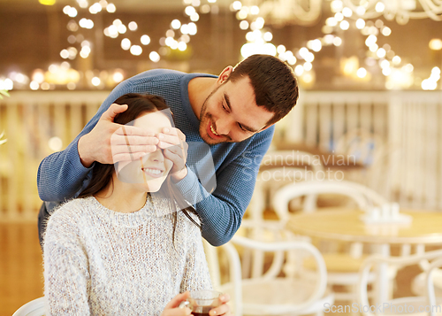 Image of happy couple drinking tea at cafe