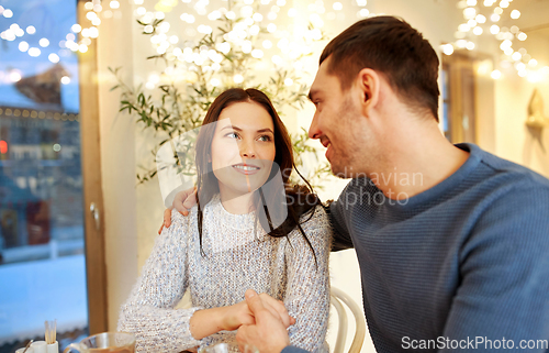 Image of happy couple drinking tea at restaurant