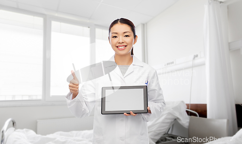 Image of asian female doctor with tablet pc shows thumbs up