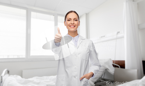 Image of happy female doctor showing thumbs up at hospital