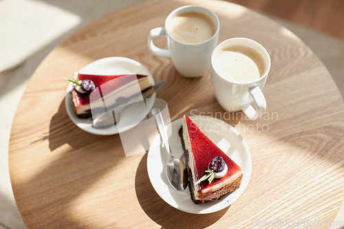 Image of pieces of chocolate cake on wooden table