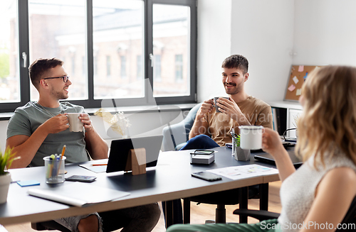 Image of team of startuppers drinking coffee at office