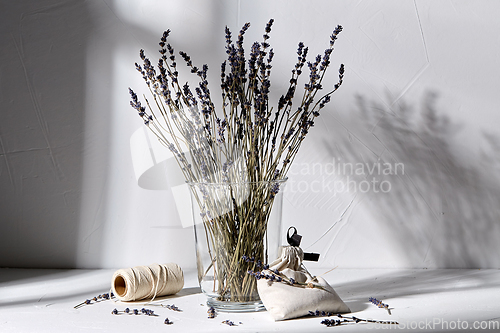 Image of sachet bag, rope and lavender flowers in vase