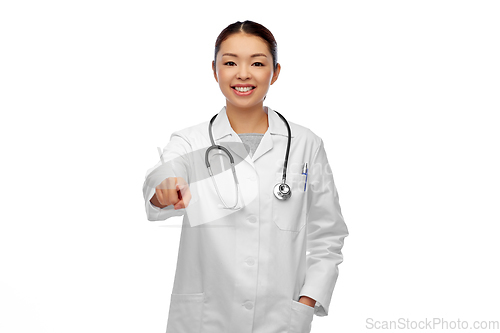 Image of happy asian female doctor pointing to camera