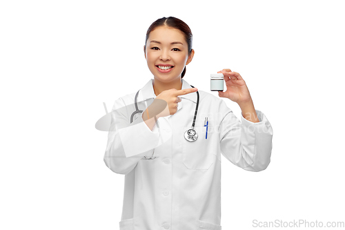 Image of smiling asian female doctor or nurse with medicine