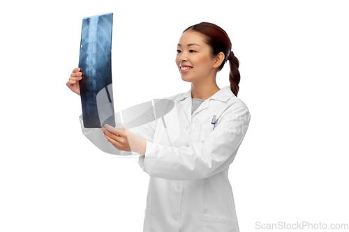 Image of asian female doctor looking at x-ray of spine