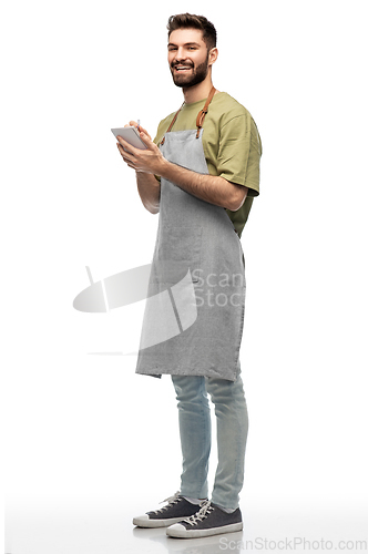 Image of smiling waiter in apron taking notes to notepad