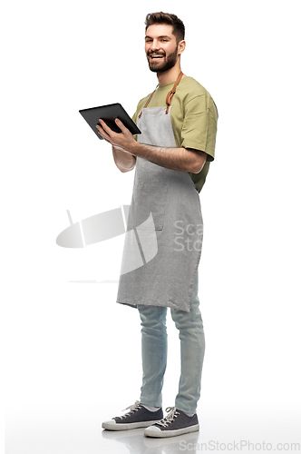 Image of smiling waiter in apron with tablet pc computer