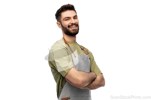 Image of happy smiling barman in apron with crossed arms