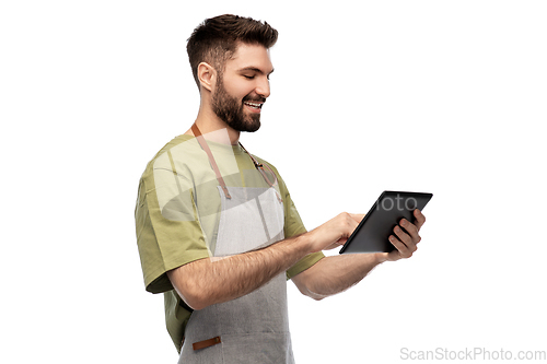 Image of smiling waiter in apron with tablet pc computer