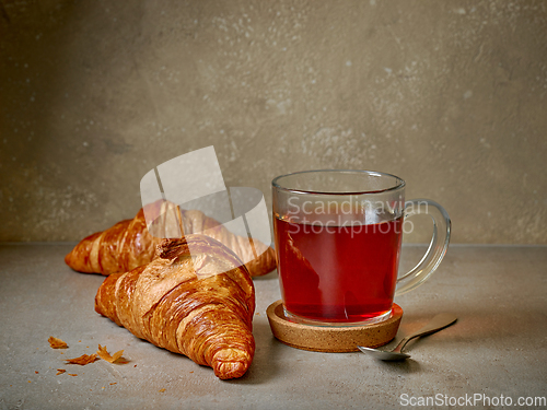 Image of close up of tea cup and croissants