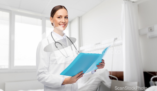 Image of smiling female doctor with folder at hospital