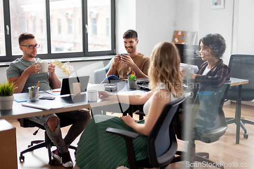 Image of team of startuppers drinking coffee at office