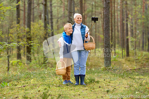 Image of grandmother and grandson with baskets take selfie