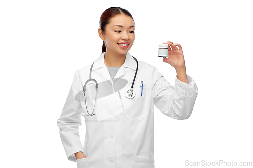 Image of smiling asian female doctor or nurse with medicine