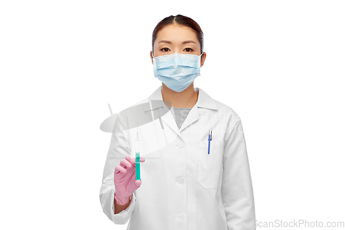 Image of asian doctor in mask with medicine in syringe